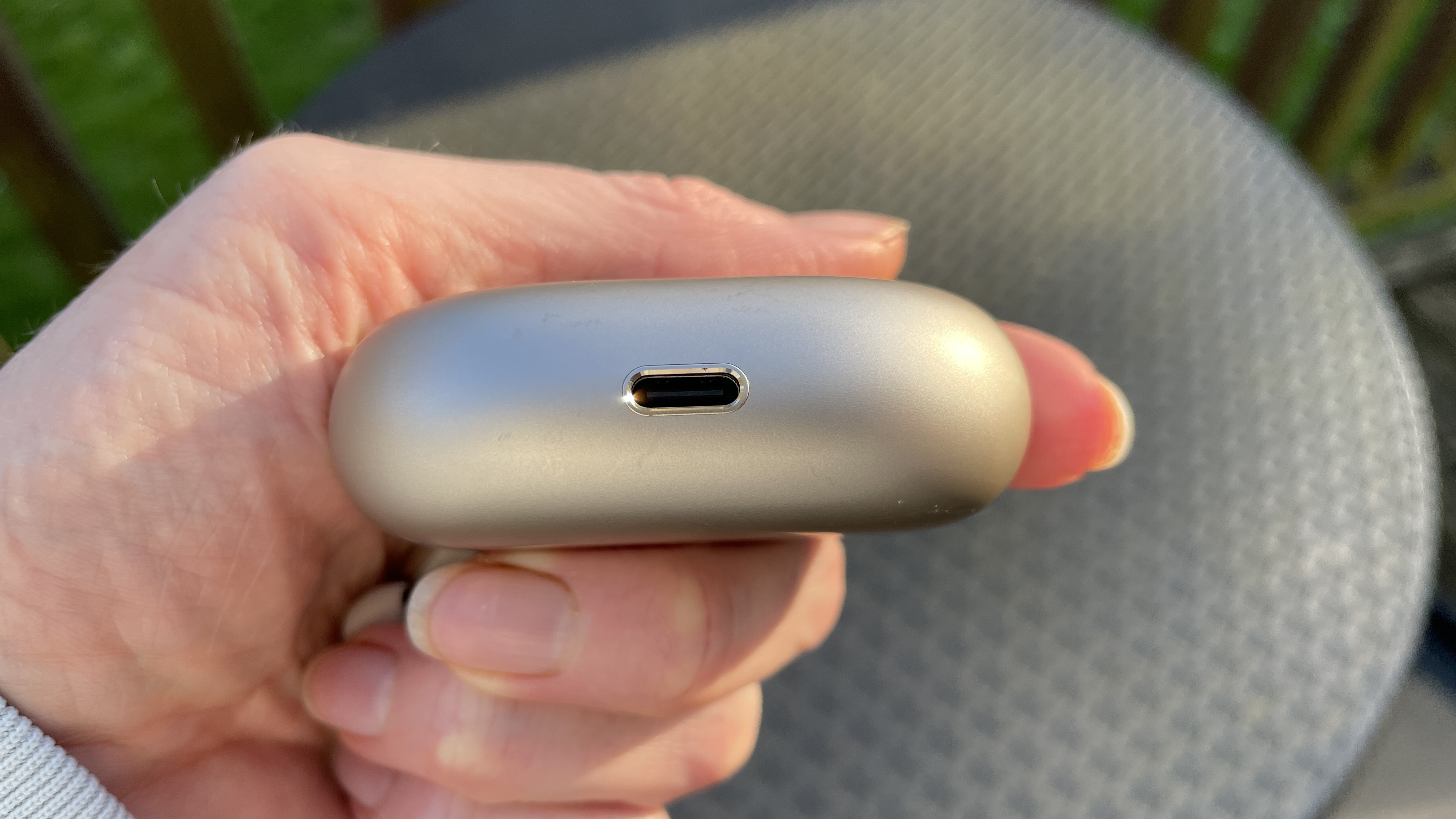 Huawei FreeBuds Pro 5 outside, near some daffodils, in the afternoon sun