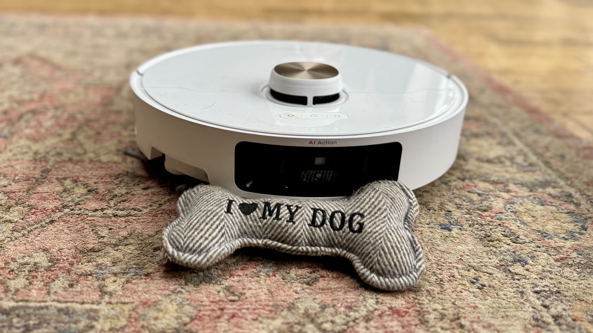 Dreame L40 Ultra robot vacuum cleaner on a carpet with a dog toy