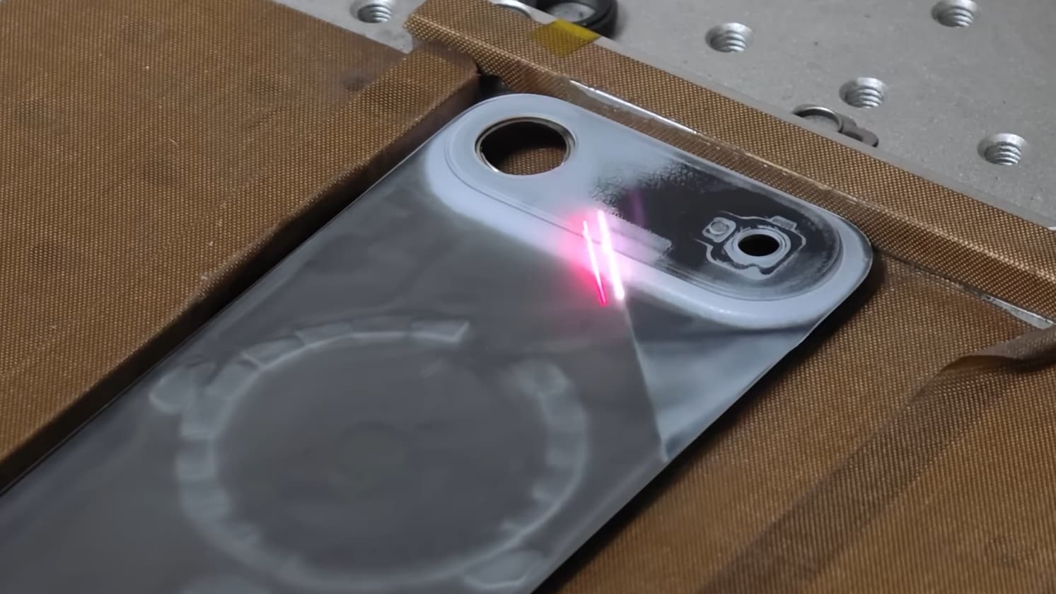 The back cover of an iPhone Air is removed with a laser to remove the paint.