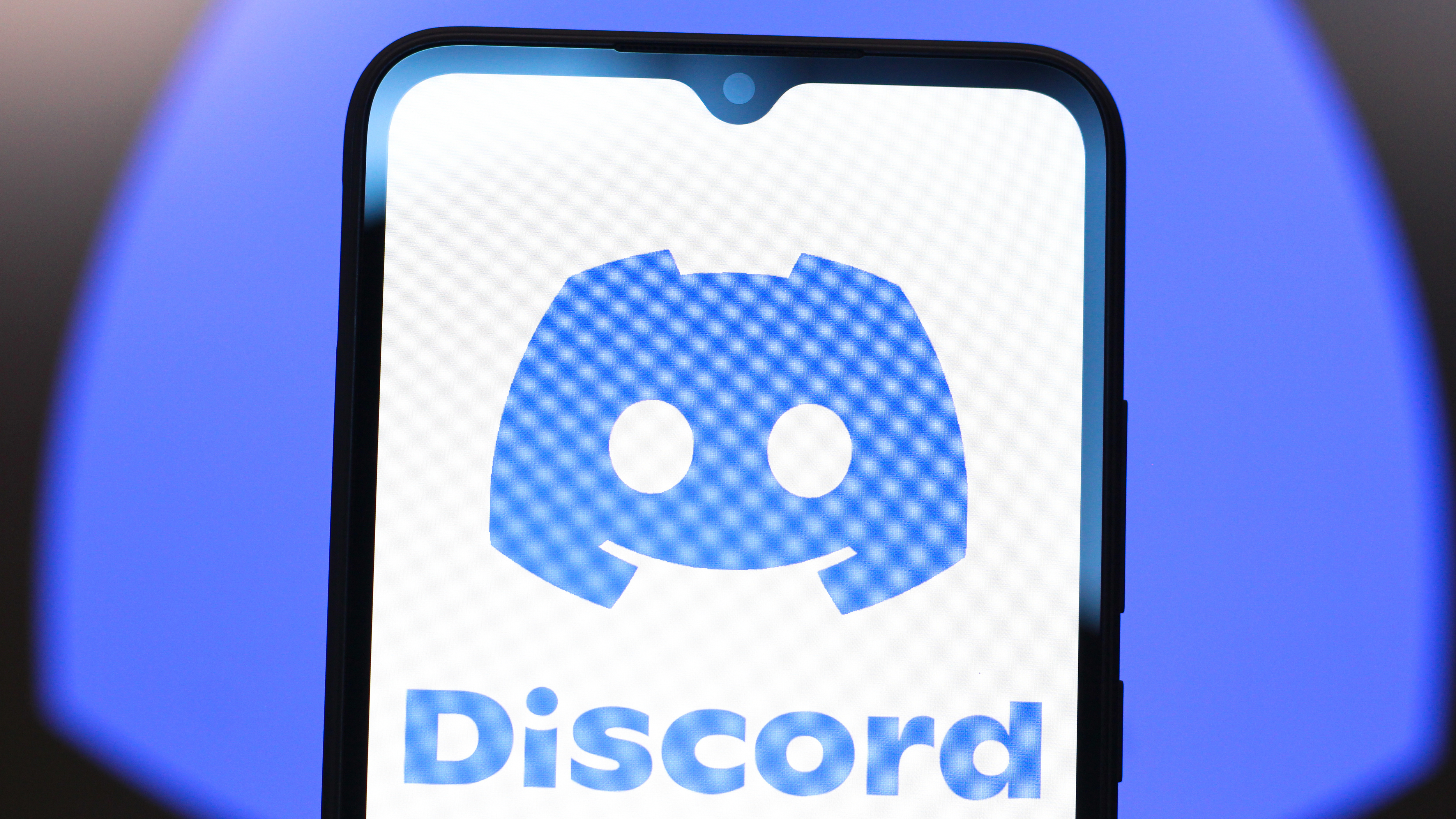 A phone displaying the Discord app and logo.