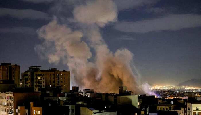 A column of smoke rises after a missile attack on a building in Tehran on March 1, 2026. — AFP