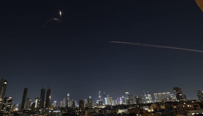 Rocket trails are seen in the sky amid a new barrage of Iranian missile attacks on the Israeli coastal city of Tel Aviv on March 3, 2026. – AFP