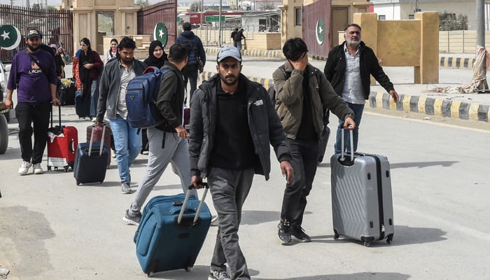 Pakistani citizens cross the Pakistan-Iran border after returning from Iran in Taftan, Balochistan province, on March 2, 2026, following the death of Iran's Supreme Leader Ayatollah Ali Khamenei amid attacks between the United States and Israel. — AFP