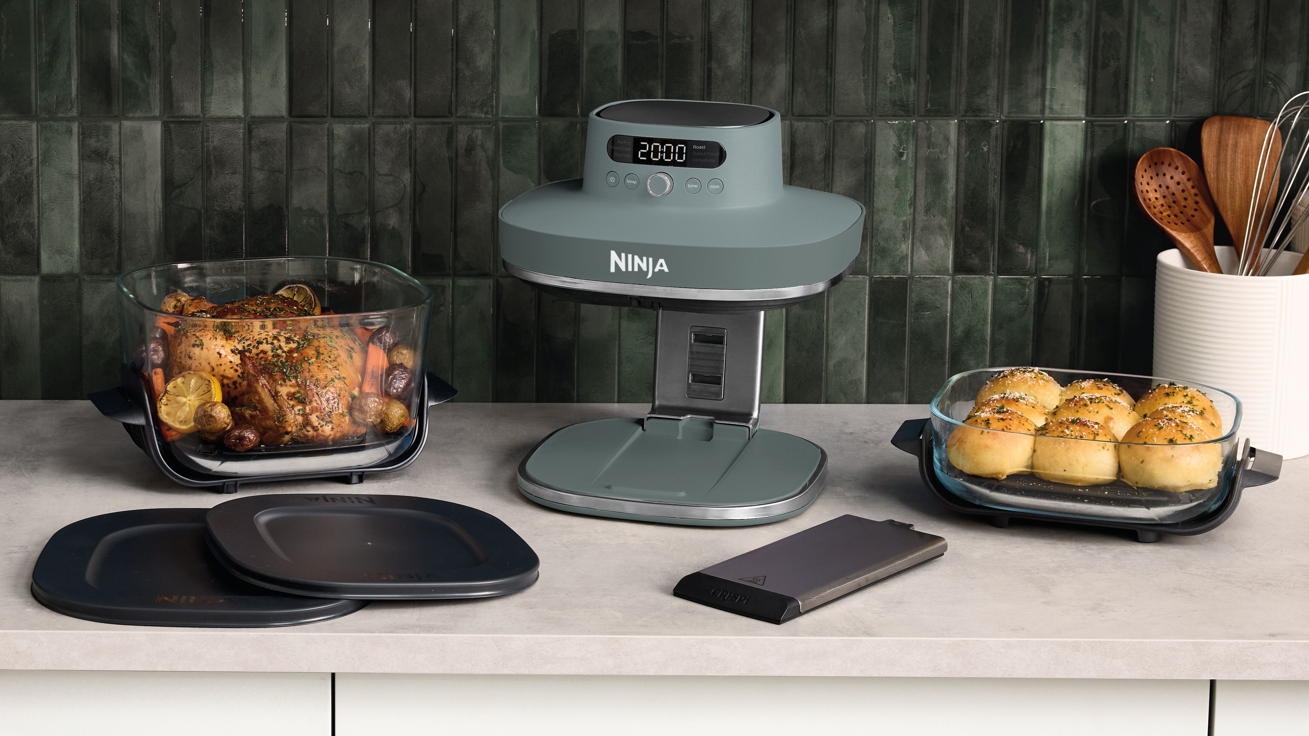 Ninja Crispi Pro fryer with food and accessories on kitchen counter