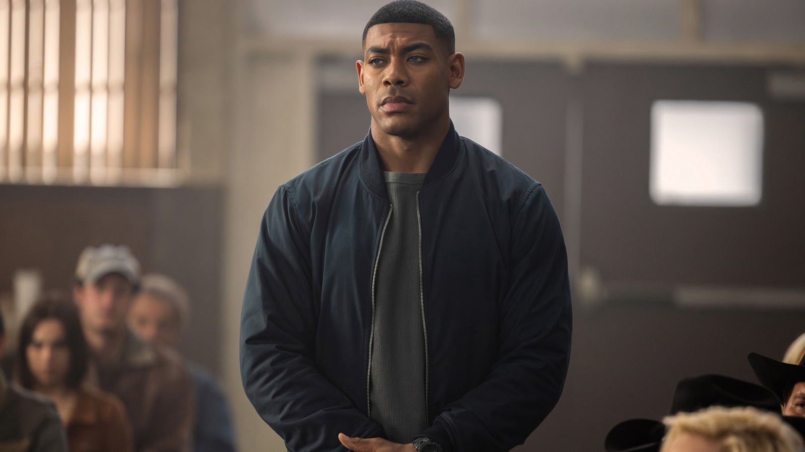 John Stewart standing with his hands crossed in front of him in Lanterns