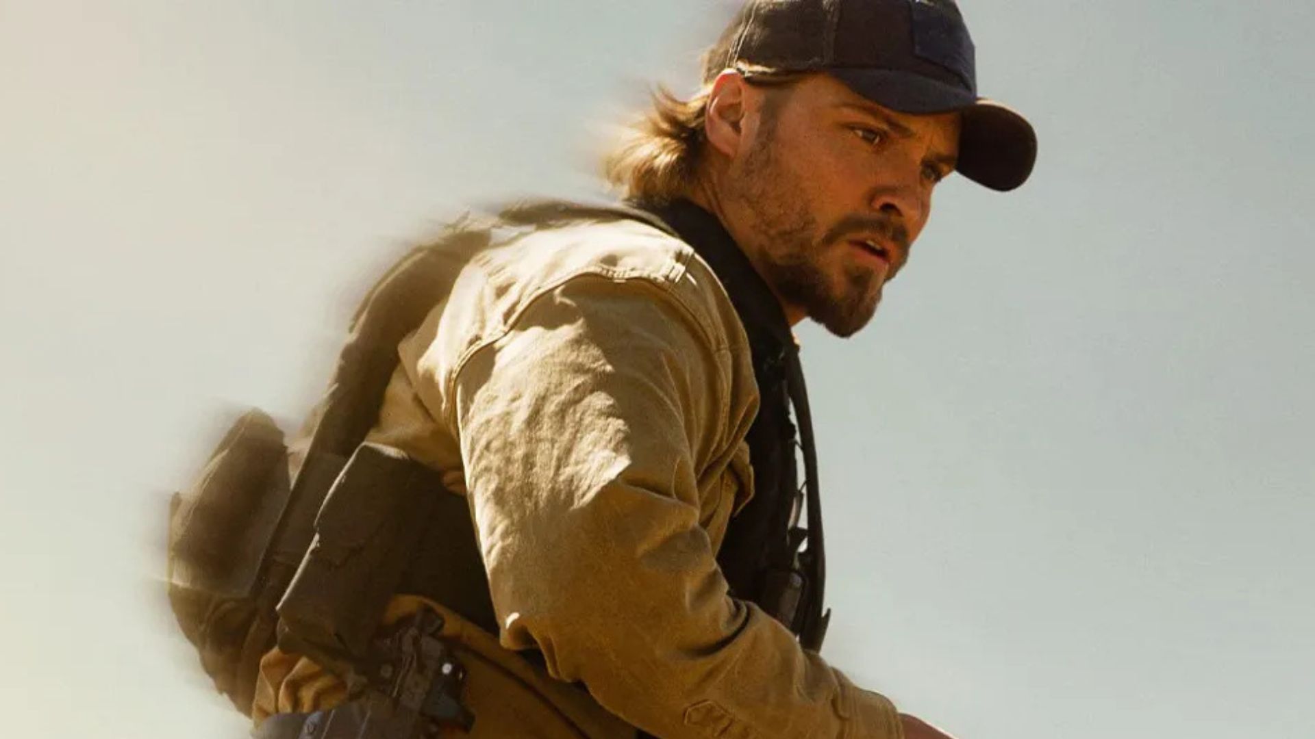 Luke Grimes looks at something off screen