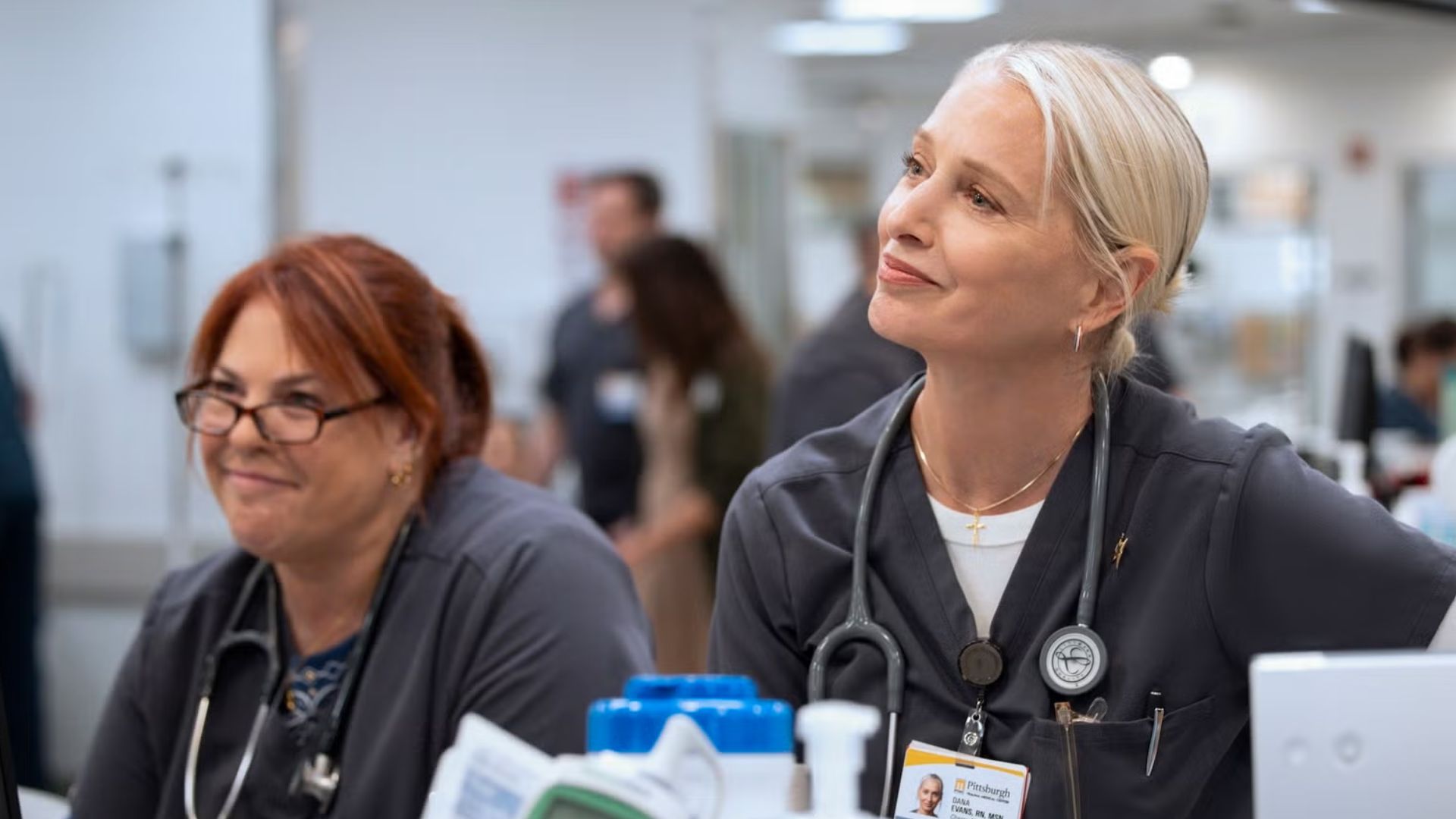 Dana and the nursing team look at something off screen.