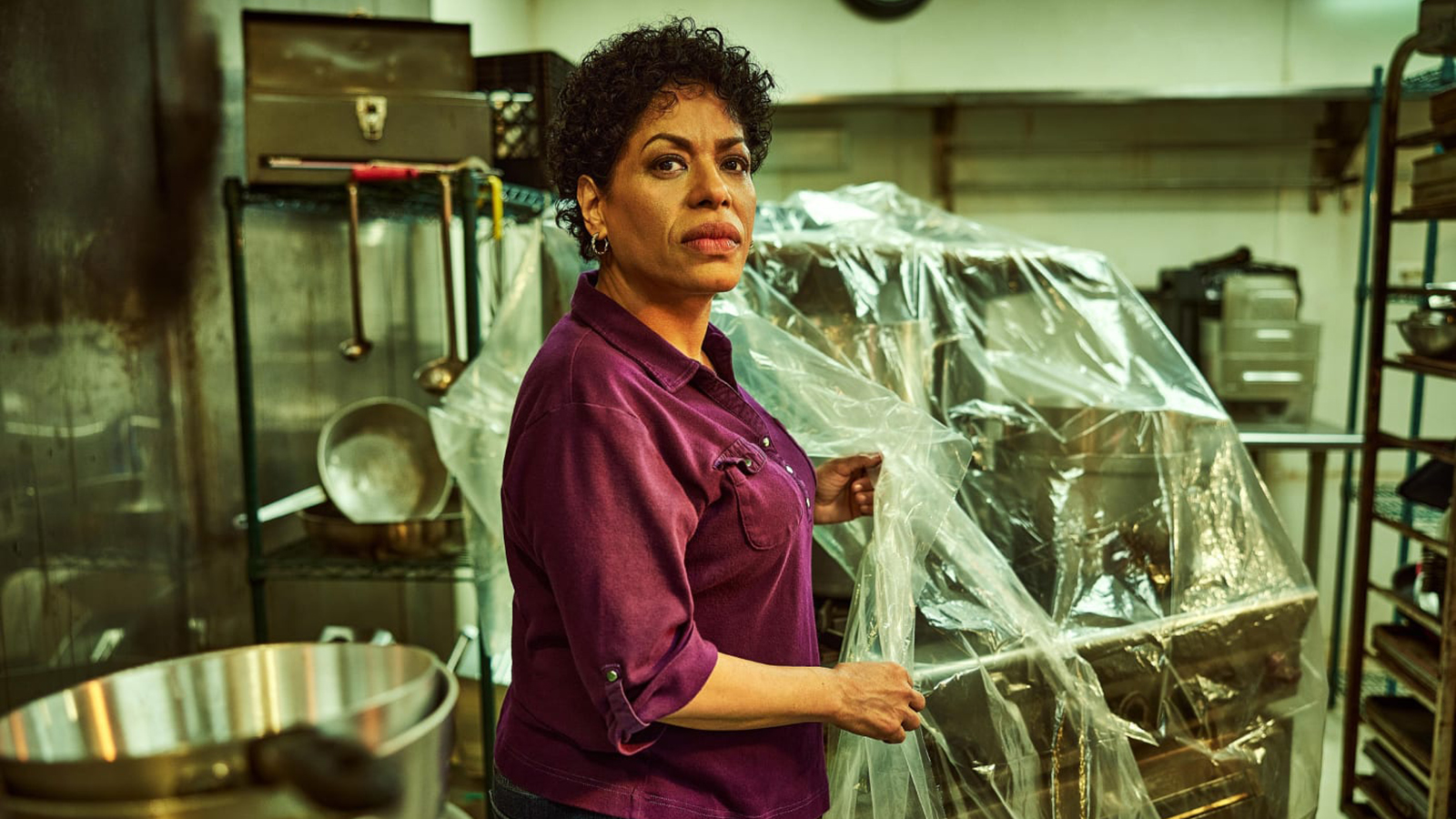Tina standing in the kitchen of a restaurant in The Bear