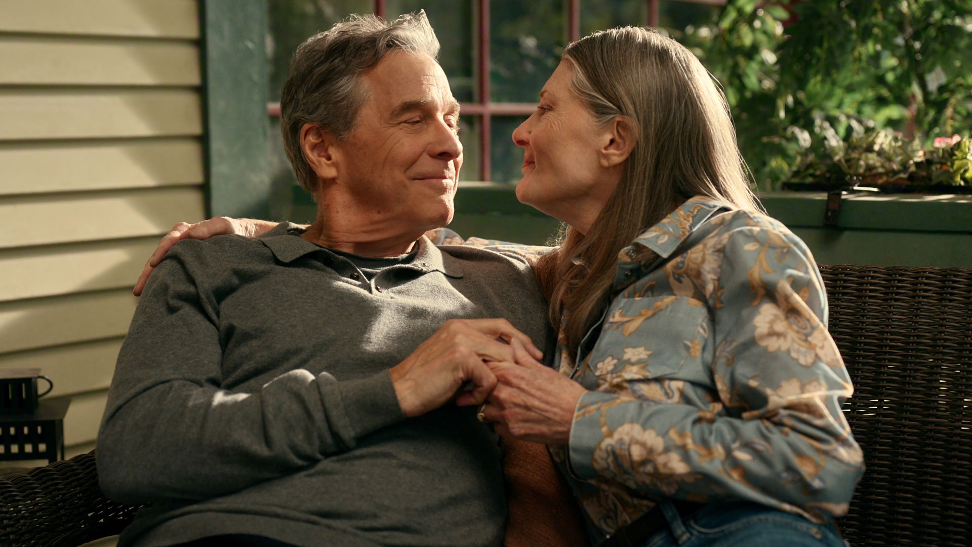 Doc and Hope hug on the porch bench