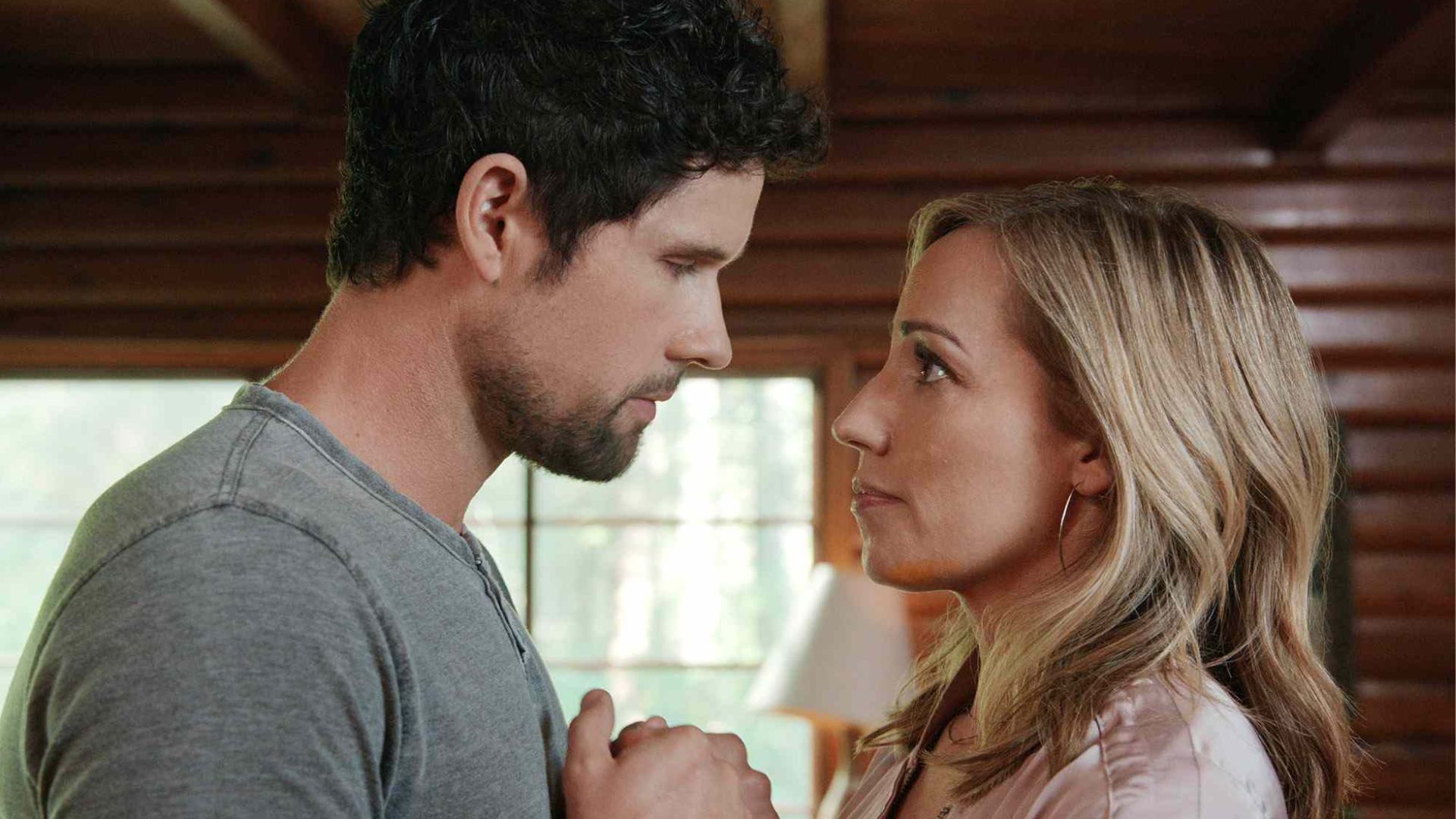 Brady holds Brie's hands while looking at her