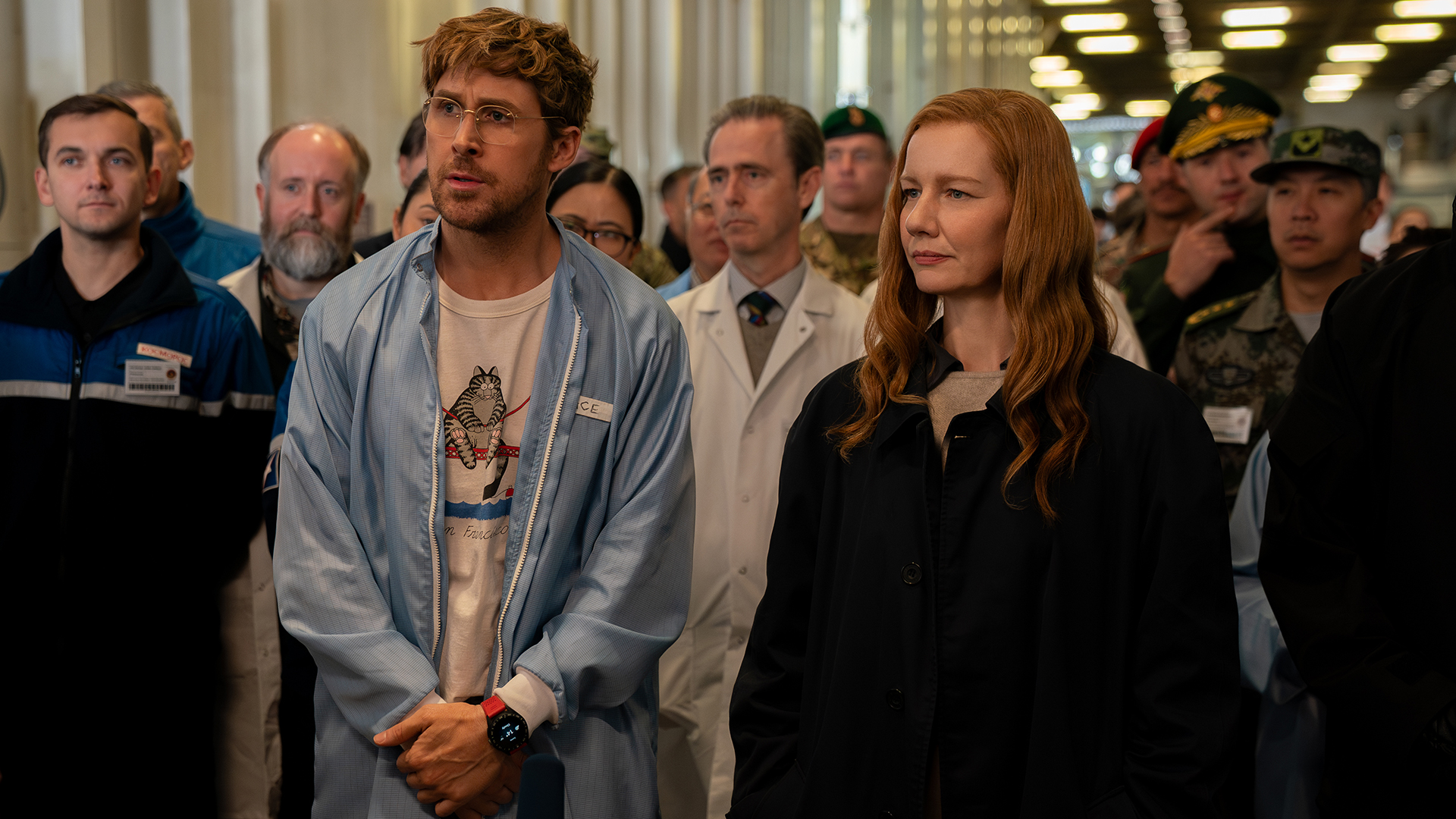 Ryland Grace and Eva Stratt watching an experiment with a group of people at Project Hail Mary