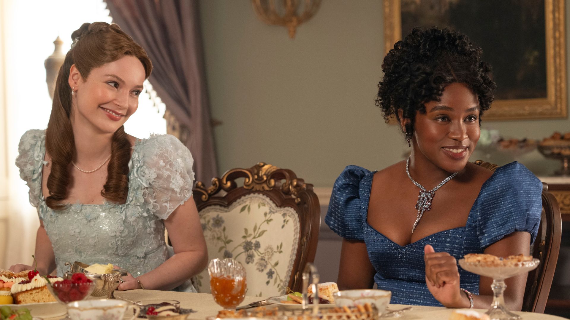 Francesca smiles at Michaela at the dining room table.