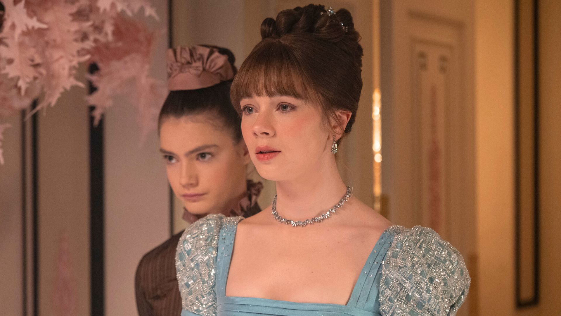 Hyacinth rests her chin on Eloise's shoulder.