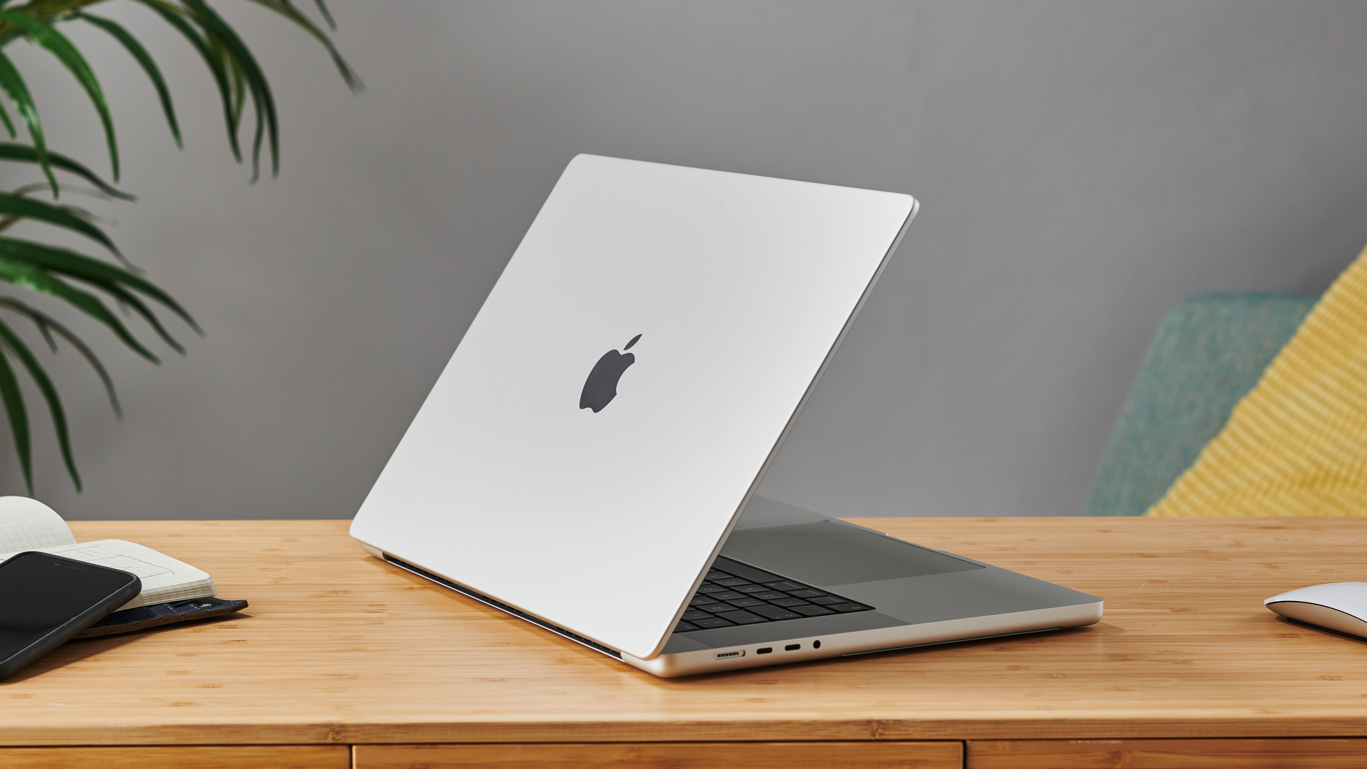16-inch MacBook Pro on a wooden table in a modern office