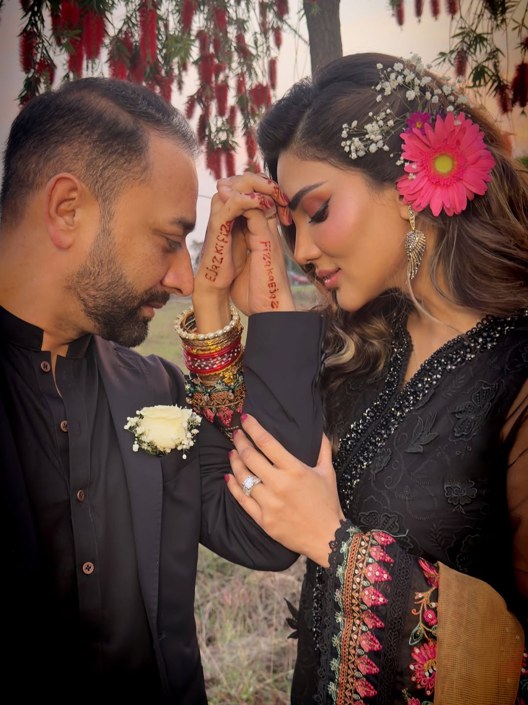 Actress Fiza Ali and her husband Ejaz Khan pose in a photo, showing their names printed with henna on each other's hands. —Instagram/@Fizaali