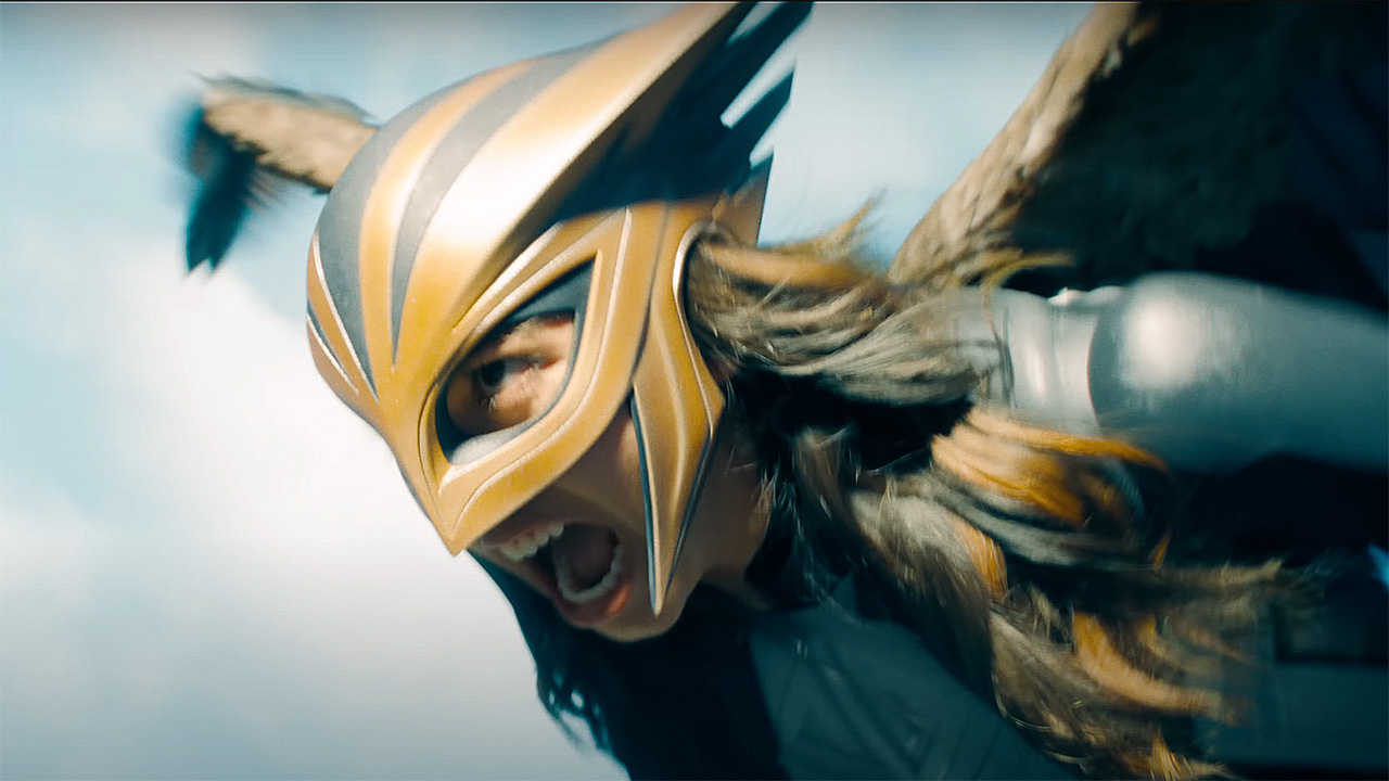 A closeup of Hawkgirl flying and screaming at Superman