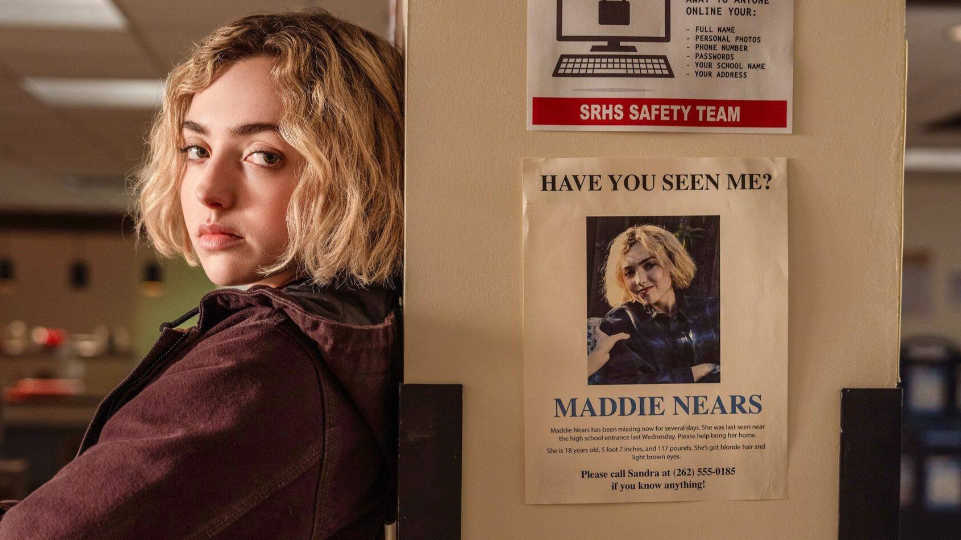 Maddie leans against a pillar with a poster of her missing.