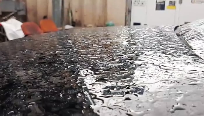 Beaded water drops rest on the hood of a car in Karachi after heavy rains in the city, April 2, 2026. — PakGazette News