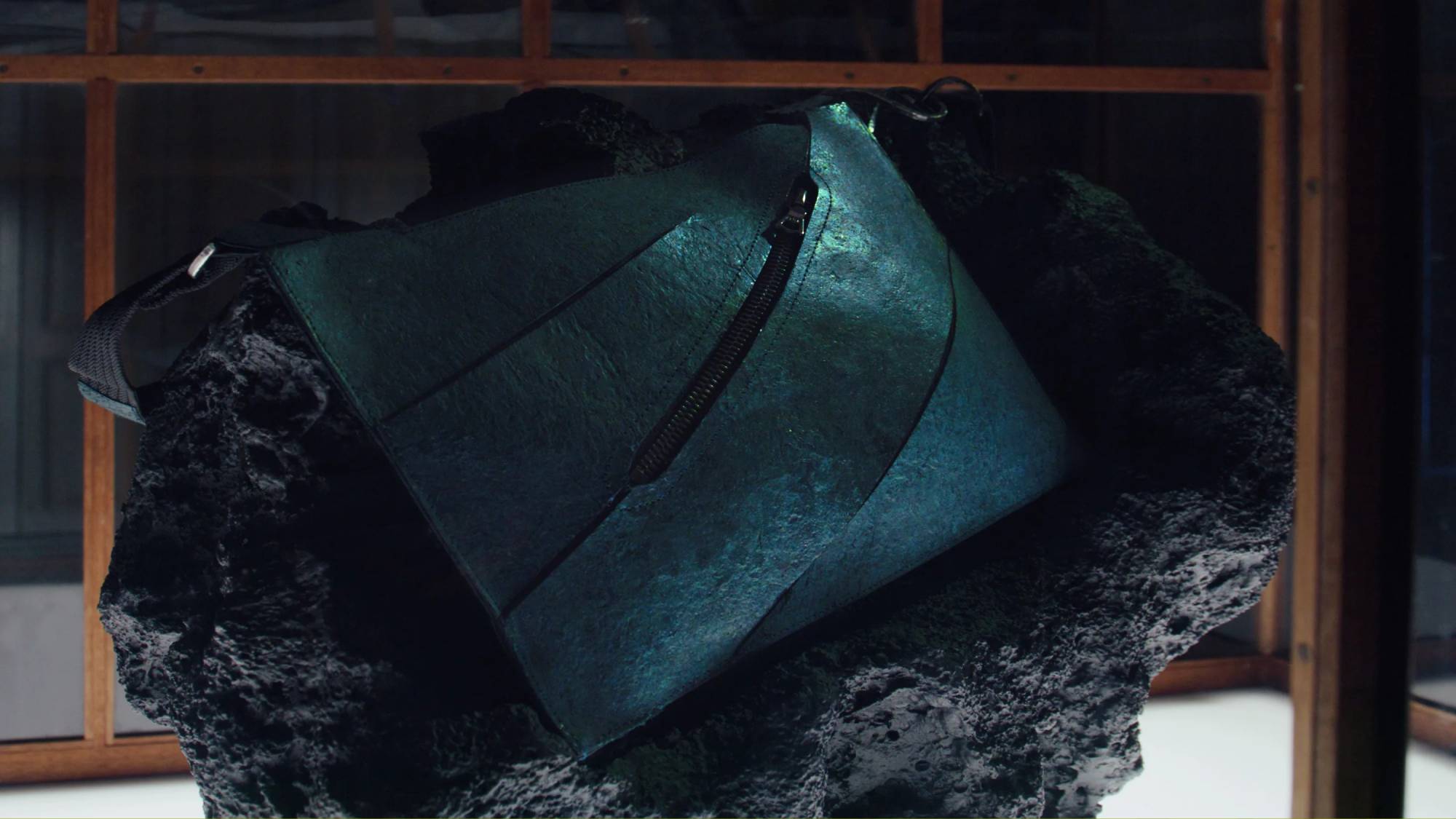 A close up of the world's first dinosaur leather product in a glass box.