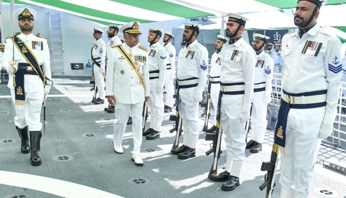 Chief of the Naval Staff Admiral Naveed Ashraf reviews the guard during the swearing-in ceremony of PNS Khaibar in this image released on April 4, 2026. – ISPR