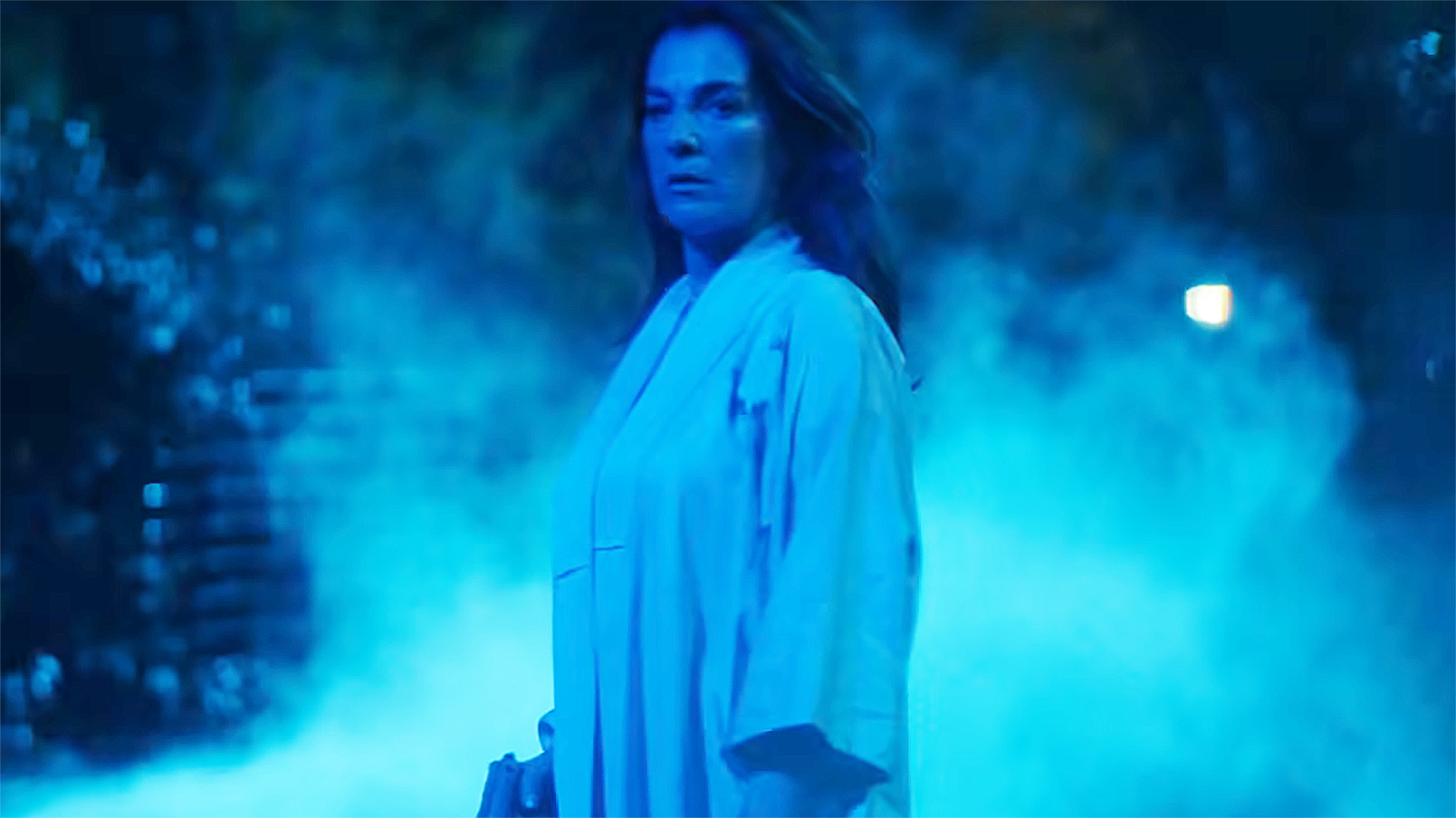 Vanessa Fisk holding a gun and bathed in blue light at night in Daredevil: Born Again season 2