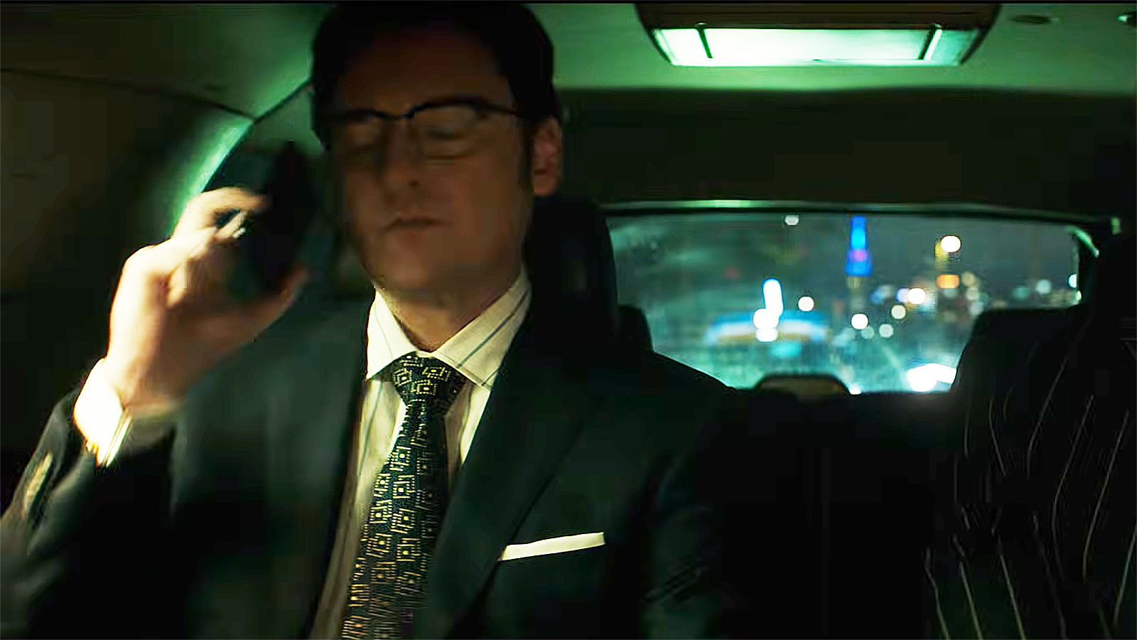 James Wesley sitting in a car and holding a mobile phone to his right ear in Daredevil: Born Again season 2, episode 5