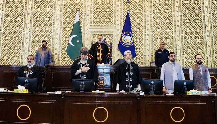 KP Assembly Speaker Babar Saleem Swati (center) performs the national anthem before presiding over the session on April 13, 2026. – Facebook/@pakpgov