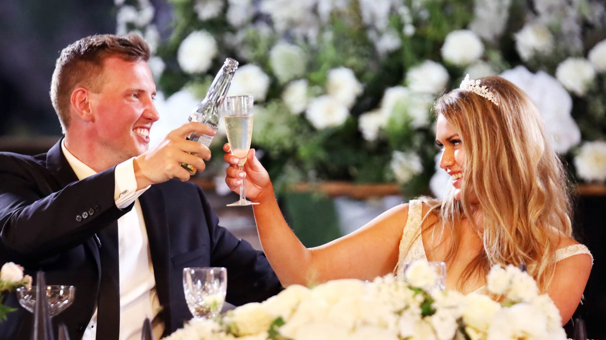 Married at First Sight Australia, bride and groom applaud with glasses of champagne