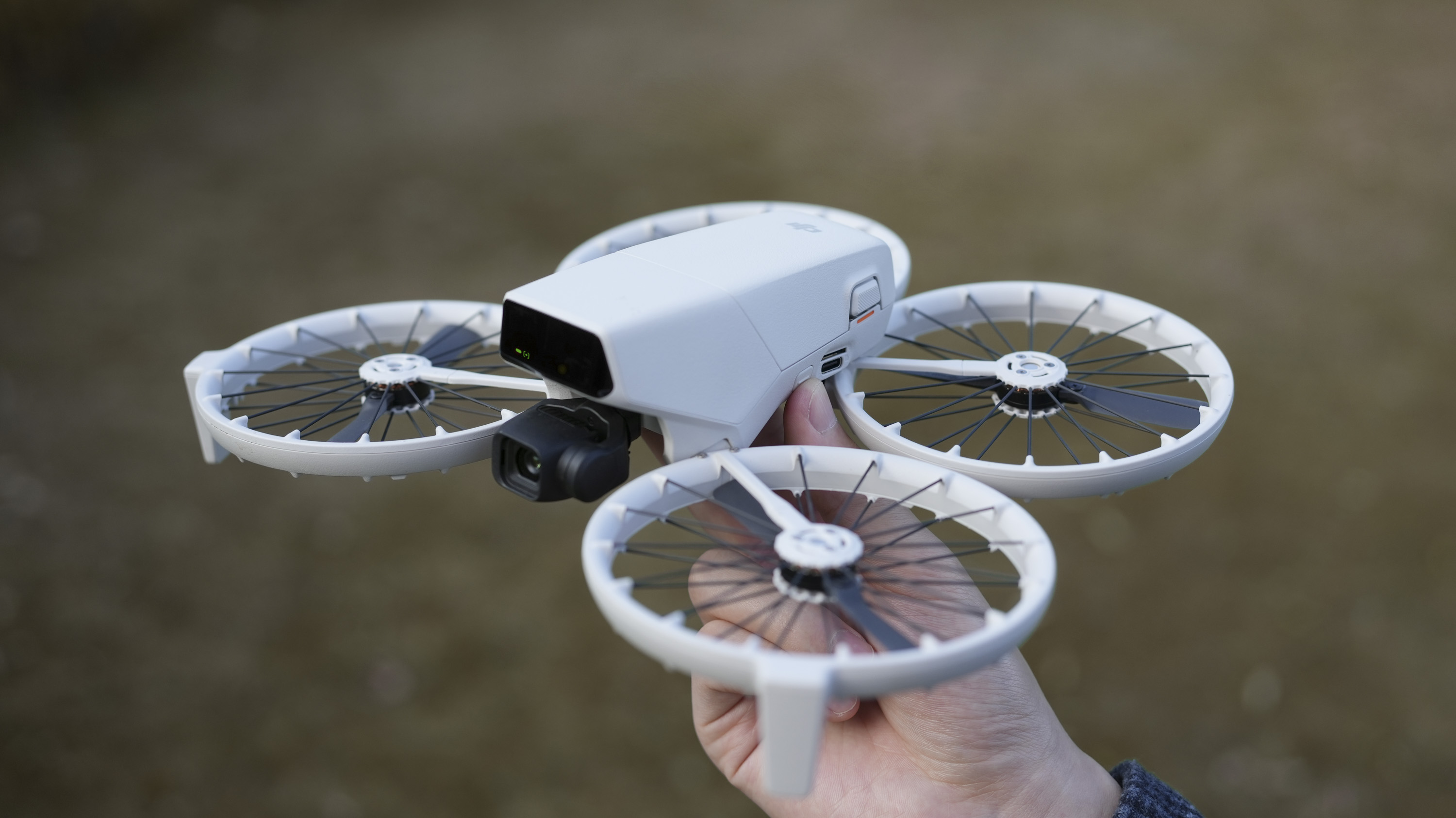 DJI Flip drone in hand, propellers deployed