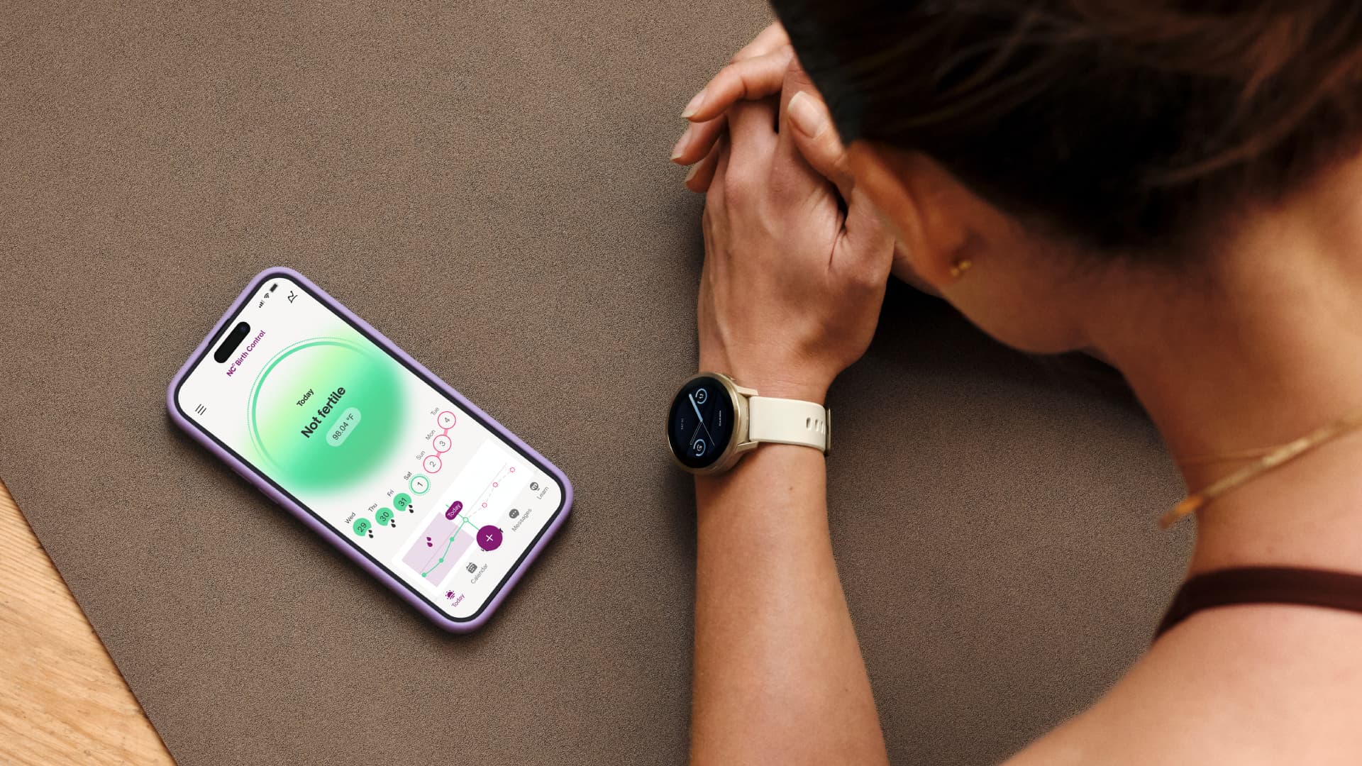 An iPhone and a Garmin smartwatch that displays a person's cycle tracking information.