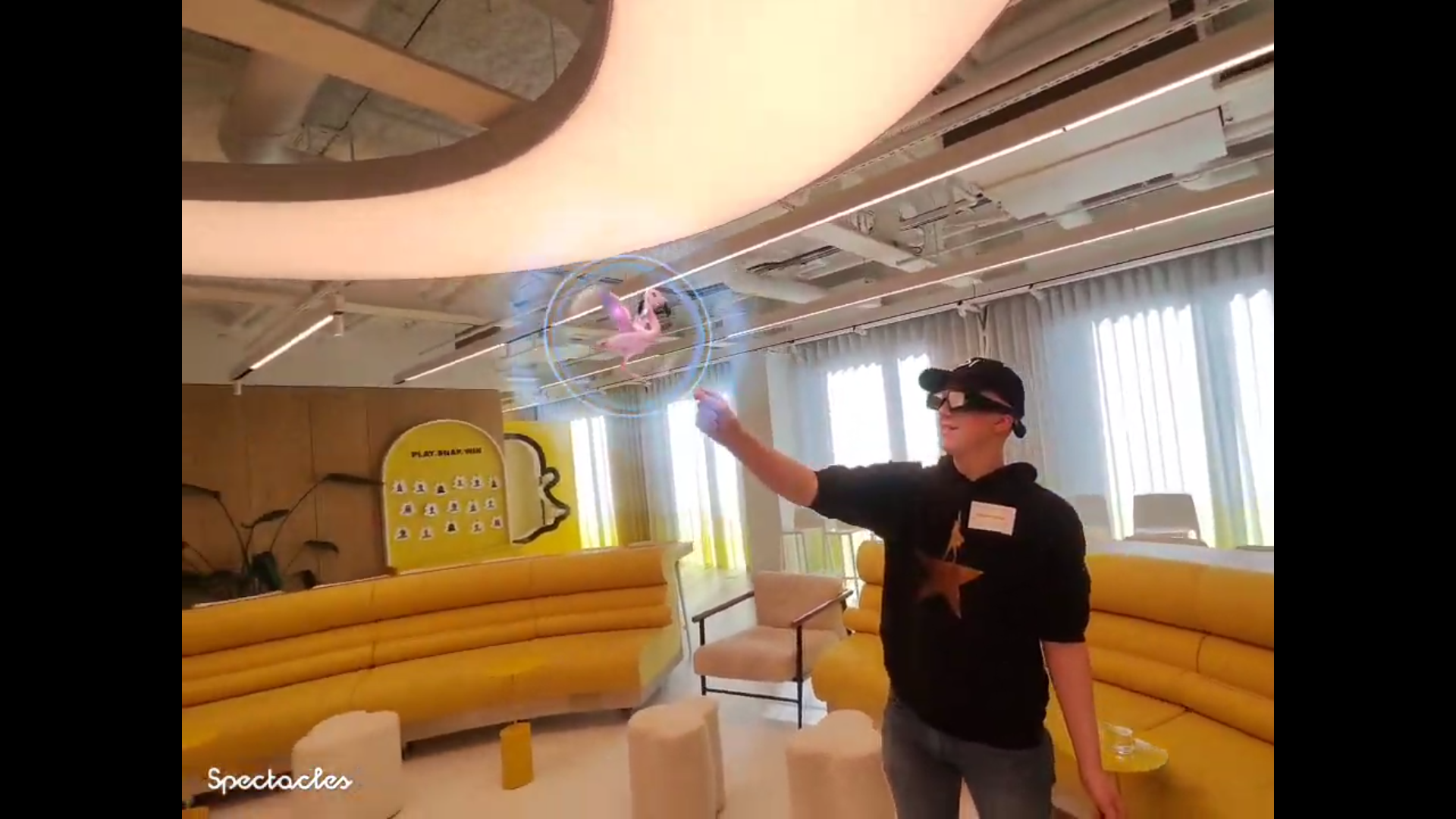 Hamish with Snap glasses playing with a flamingo AR