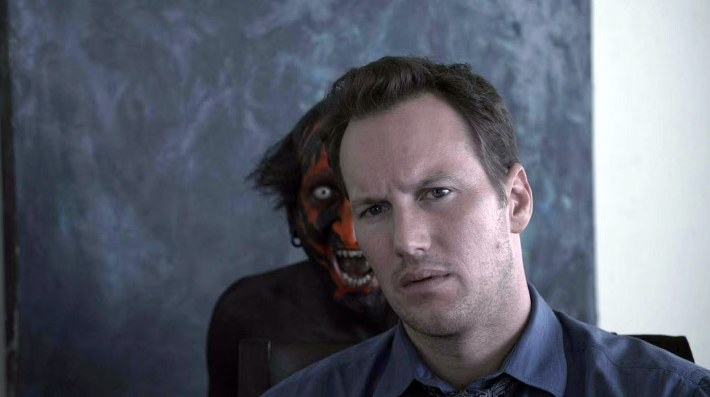 Patrick Wilson with a red demon behind him in the first Insidious