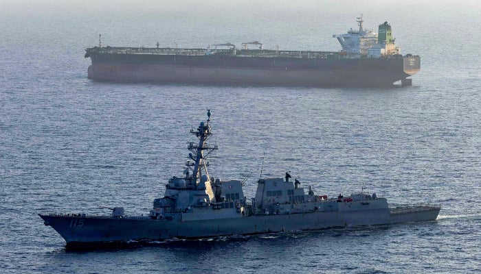 This U.S. Navy photo, released May 7, 2026, by U.S. Central Command Public Affairs, shows the Arleigh Burke-class guided-missile destroyer USS Rafael Peralta (DDG 115) implementing a sea blockade against the Iranian-flagged oil tanker Stream as the latter attempted to sail toward an Iranian port, April 26, 2026. - AFP