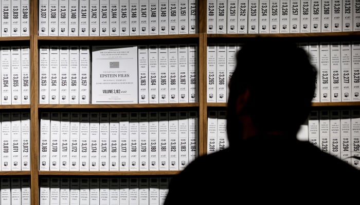 Visitors view a timeline of events in the Donald J. Trump and Jeffrey Epstein Memorial Reading Room, a tribute to the survivors and victims of Epstein's crimes, where 3.5 million pages and 3,437 bound volumes from Epstein's archives are on display in New York City on May 11, 2026. — AFP