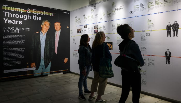 Visitors view a timeline of events in the Donald J. Trump and Jeffrey Epstein Memorial Reading Room, a tribute to the survivors and victims of Epstein's crimes, where 3.5 million pages and 3,437 bound volumes from Epstein's archives are on display in New York City on May 11, 2026. — AFP