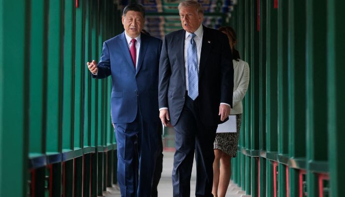 U.S. President Donald Trump takes part in a friendship walk through Zhongnanhai Garden with Chinese President Xi Jinping in Beijing, China, May 15, 2026. – Reuters