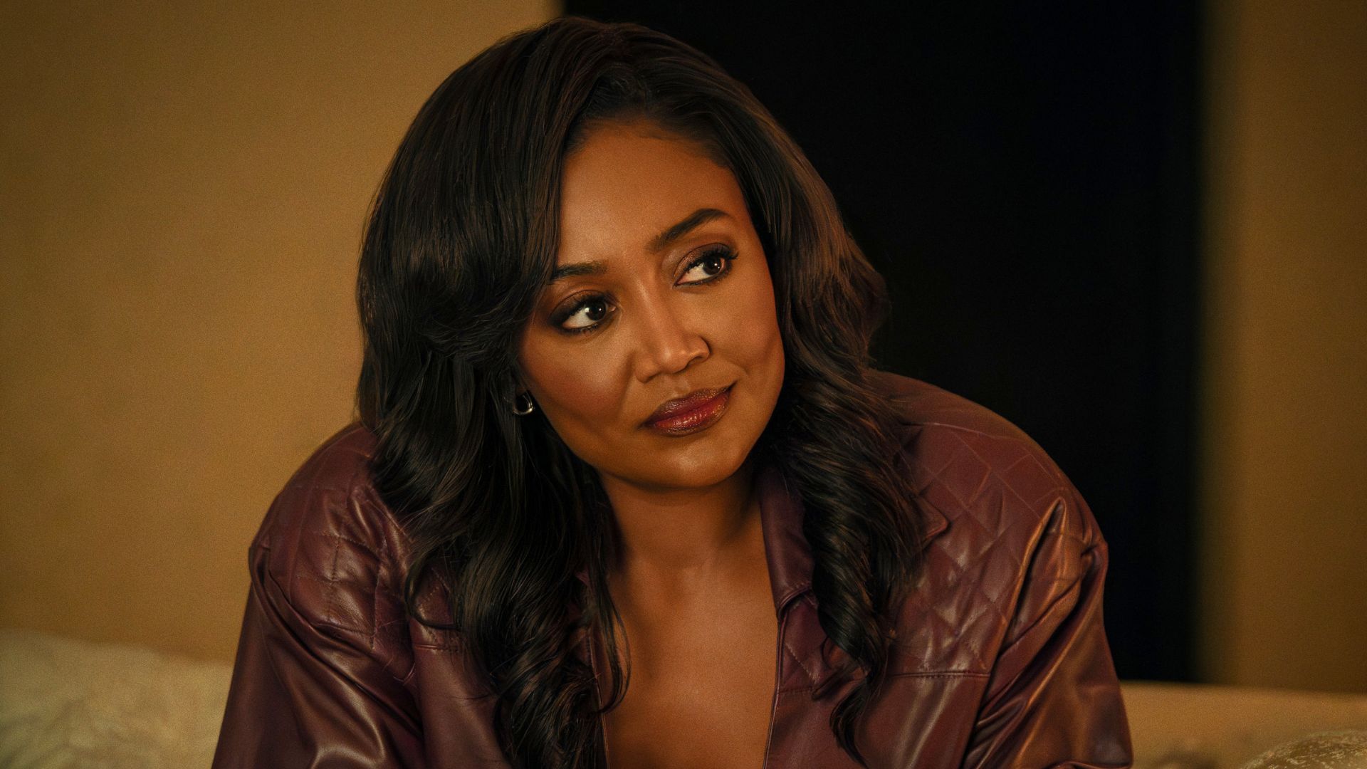 Raq looks at something off screen.
