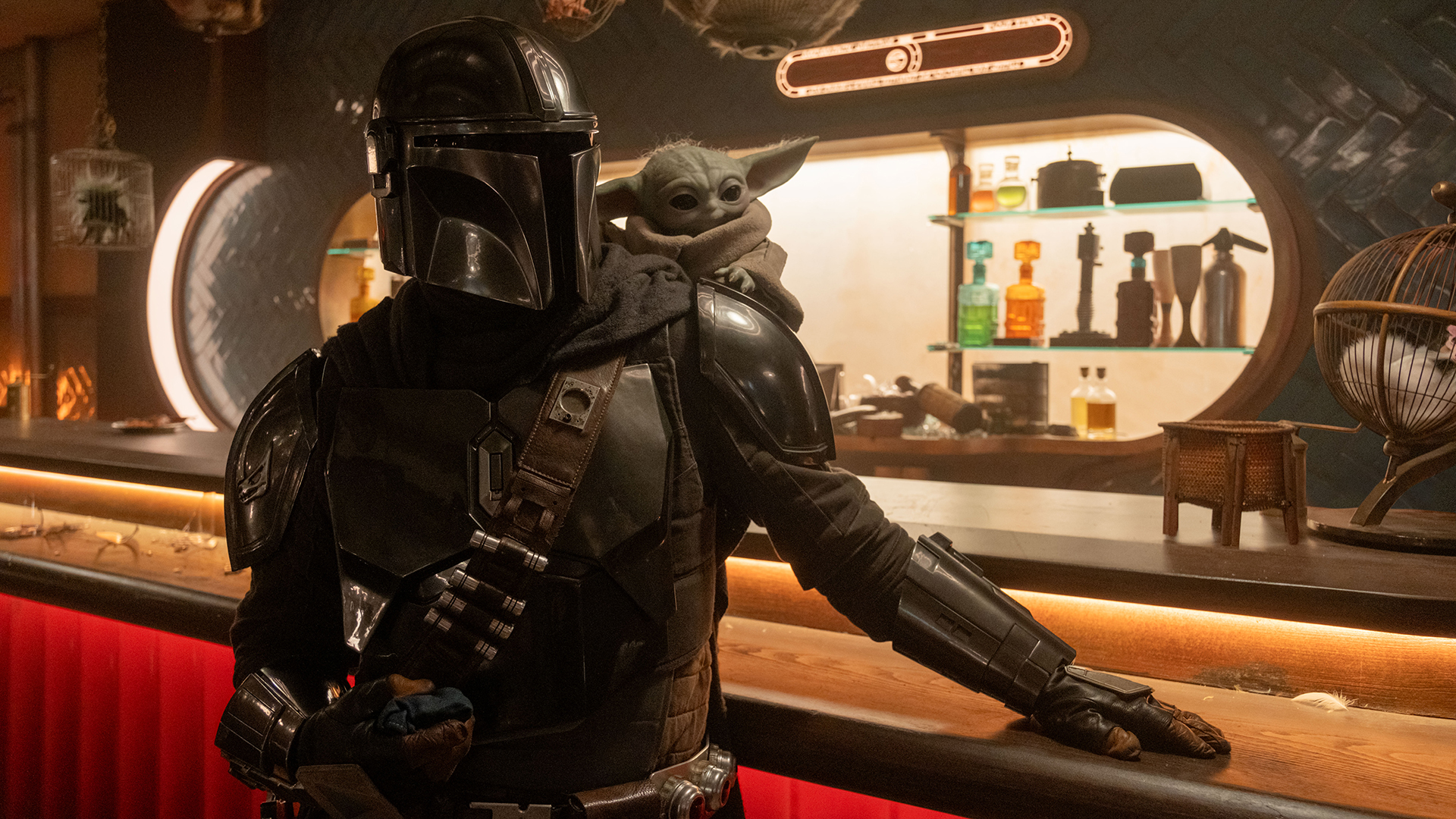Din Djarin and Baby Yoda standing at a bar in The Mandalorian and Grogu