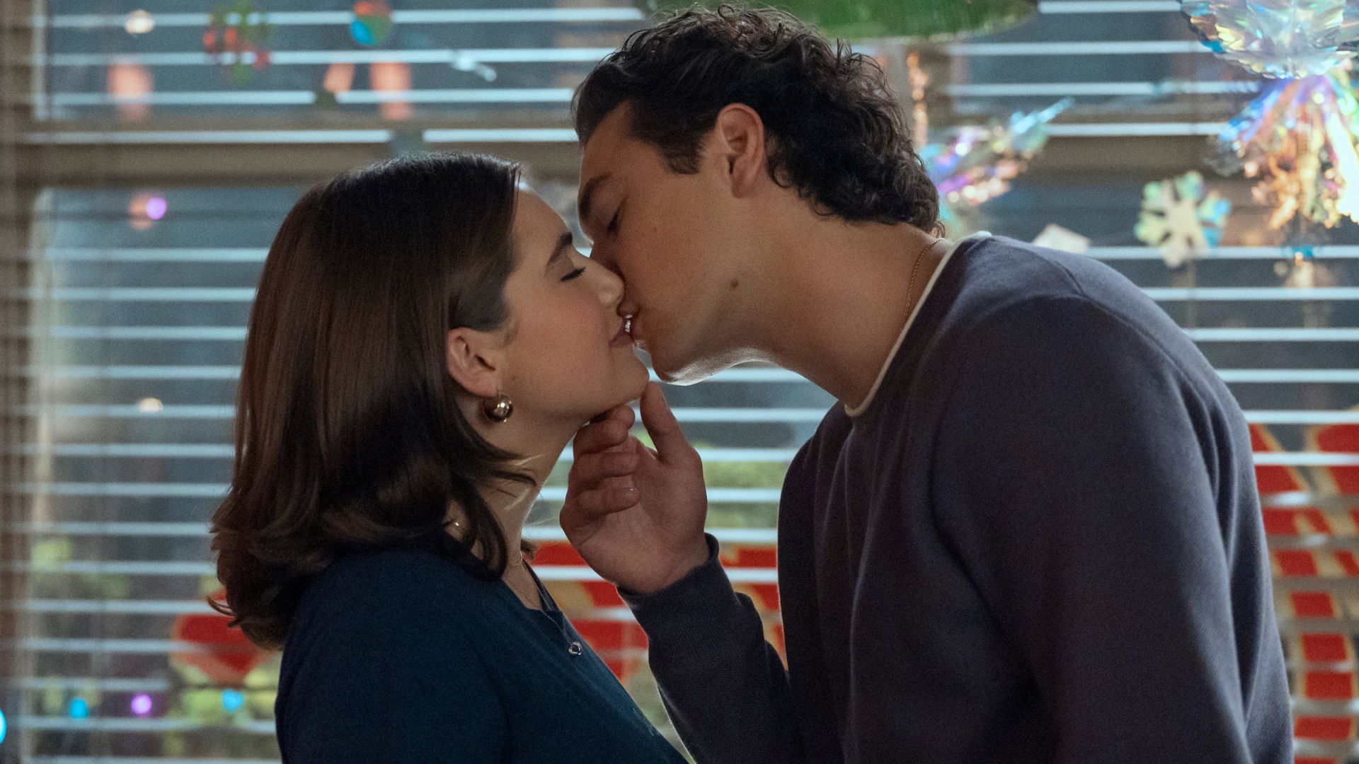 A young couple kiss