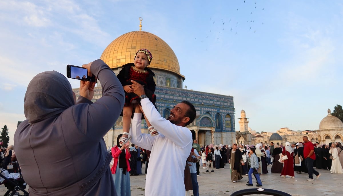 Palestinian families celebrate Eid ul Adha at the Al-Aqsa mosque in Jerusalem on May 27, 2026. – Reuters