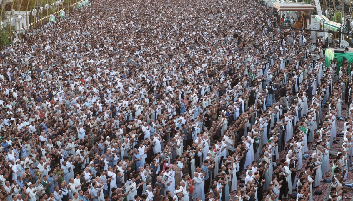 Muslim worshipers perform Eid ul Adha prayers between the shrines of Imam Hussein and Imam Abbas in the holy city of Karbala, Iraq, on May 27, 2026. – Reuters