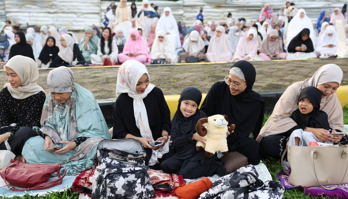 A girl holds a doll as she attends to offer mass Eid ul Adha prayers at the Al Azhar Grand Mosque in Jakarta, Indonesia, May 27, 2026. – Reuters