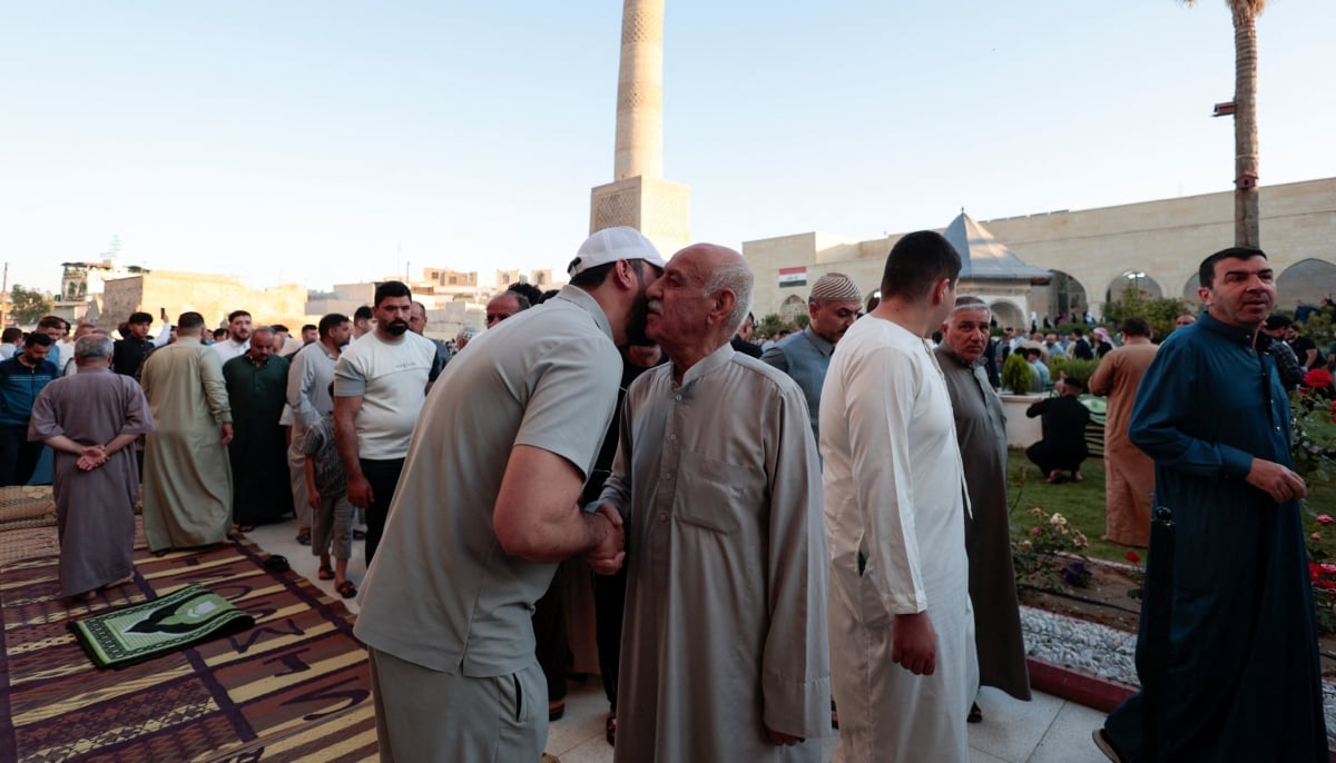 Muslims exchange greetings after the Eid ul Adha prayer, in Mosul, Iraq, on May 27, 2026. – Reuters