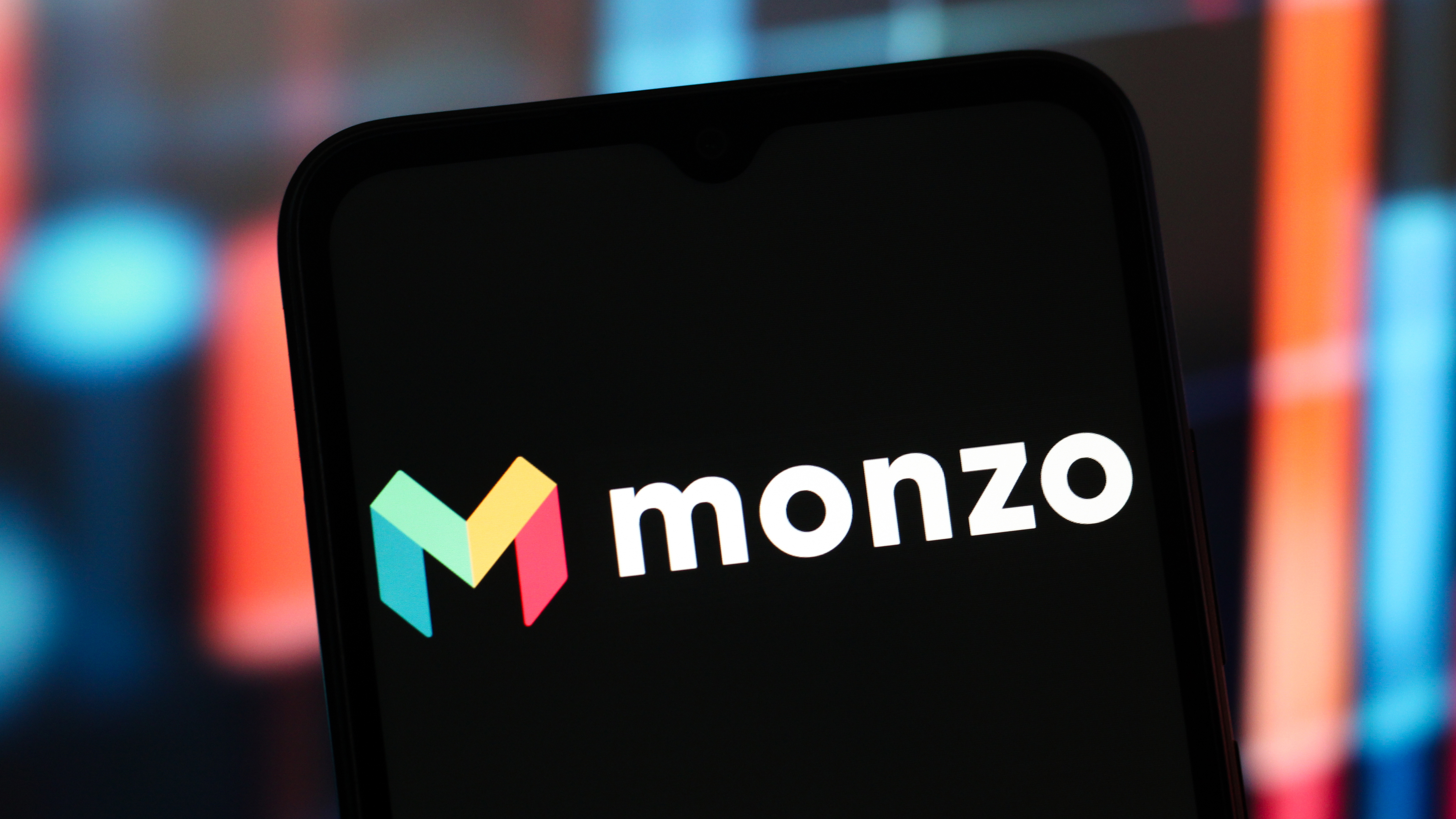 A phone displaying the Monzo logo.