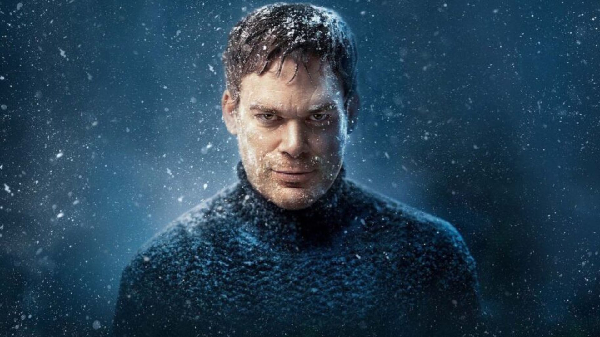 Dexter is wearing a navy blue knit turtleneck, starting directly from the snow-covered lens.