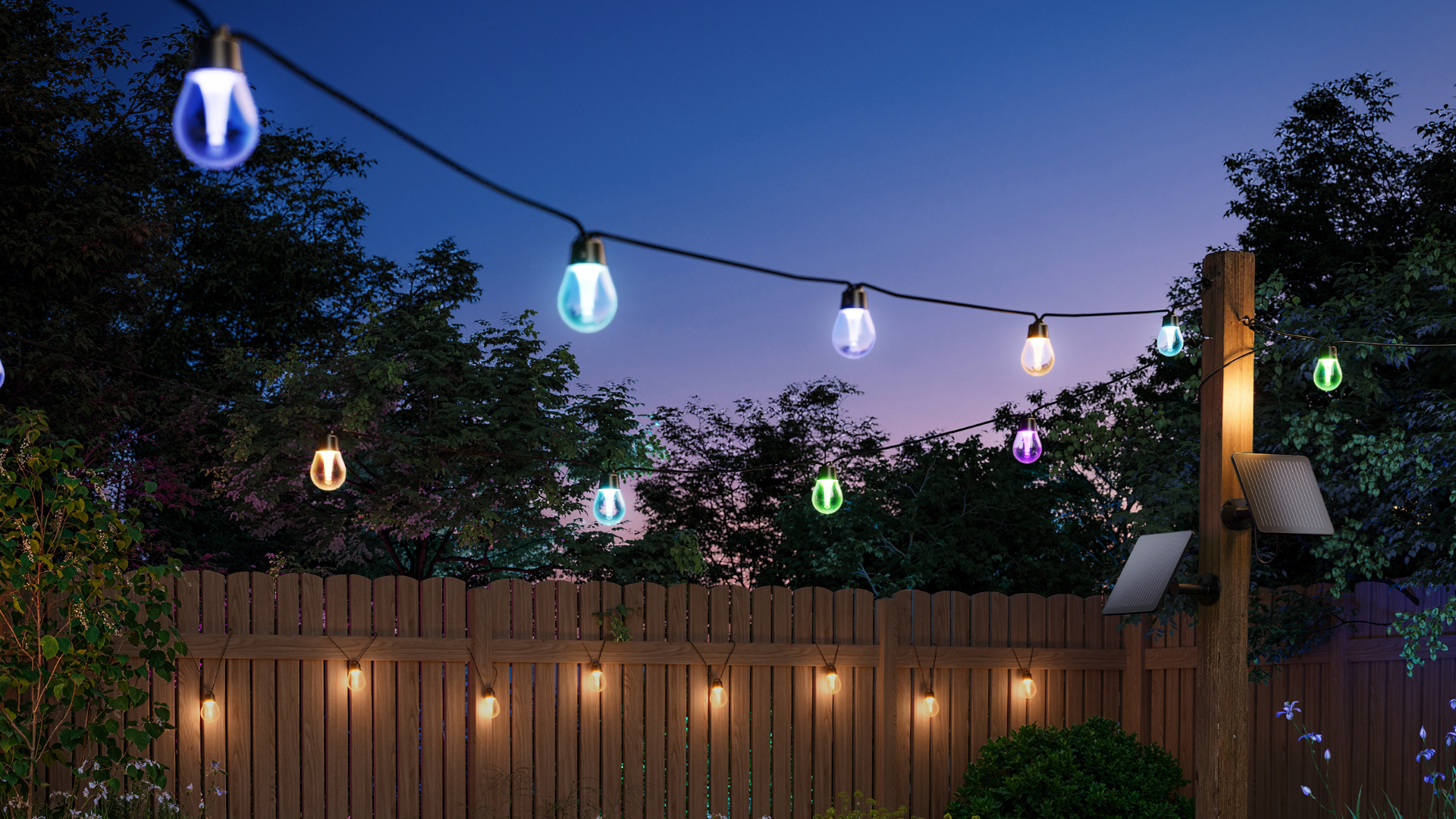 Govee Outdoor Solar String Lights Suspended from a Line and Hung on a Fence at Dusk