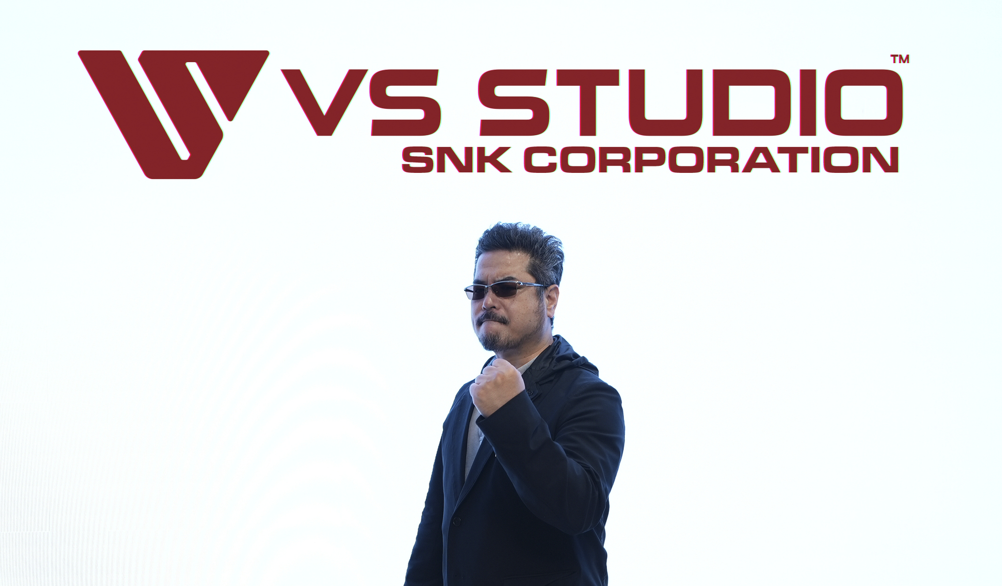 VK Studio CEO Katsuhiro Harada stands in front of the studio's logo.