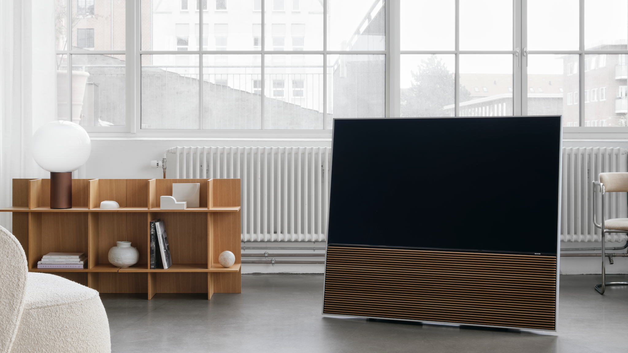 Canvas L sound bar connected to a TV in a well-lit, neutrally decorated room in front of large windows