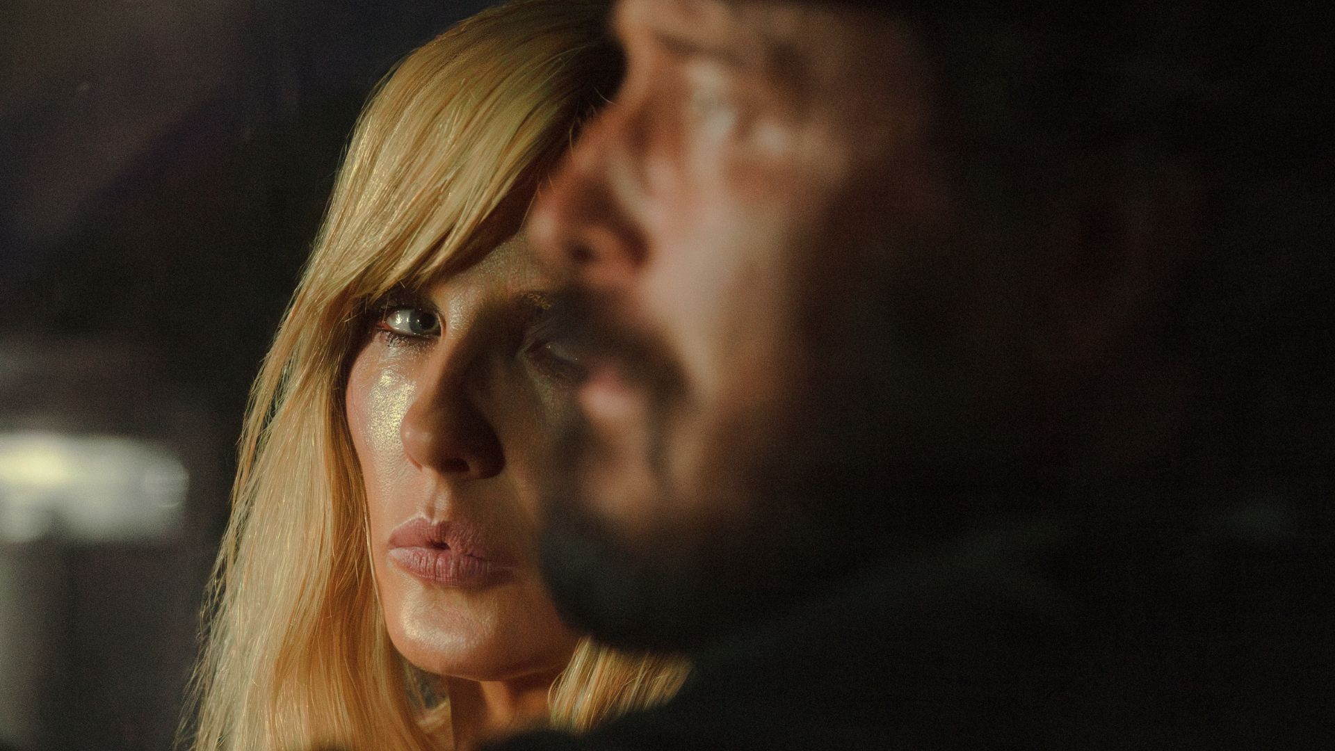 Beth looks at Rip sitting next to her.