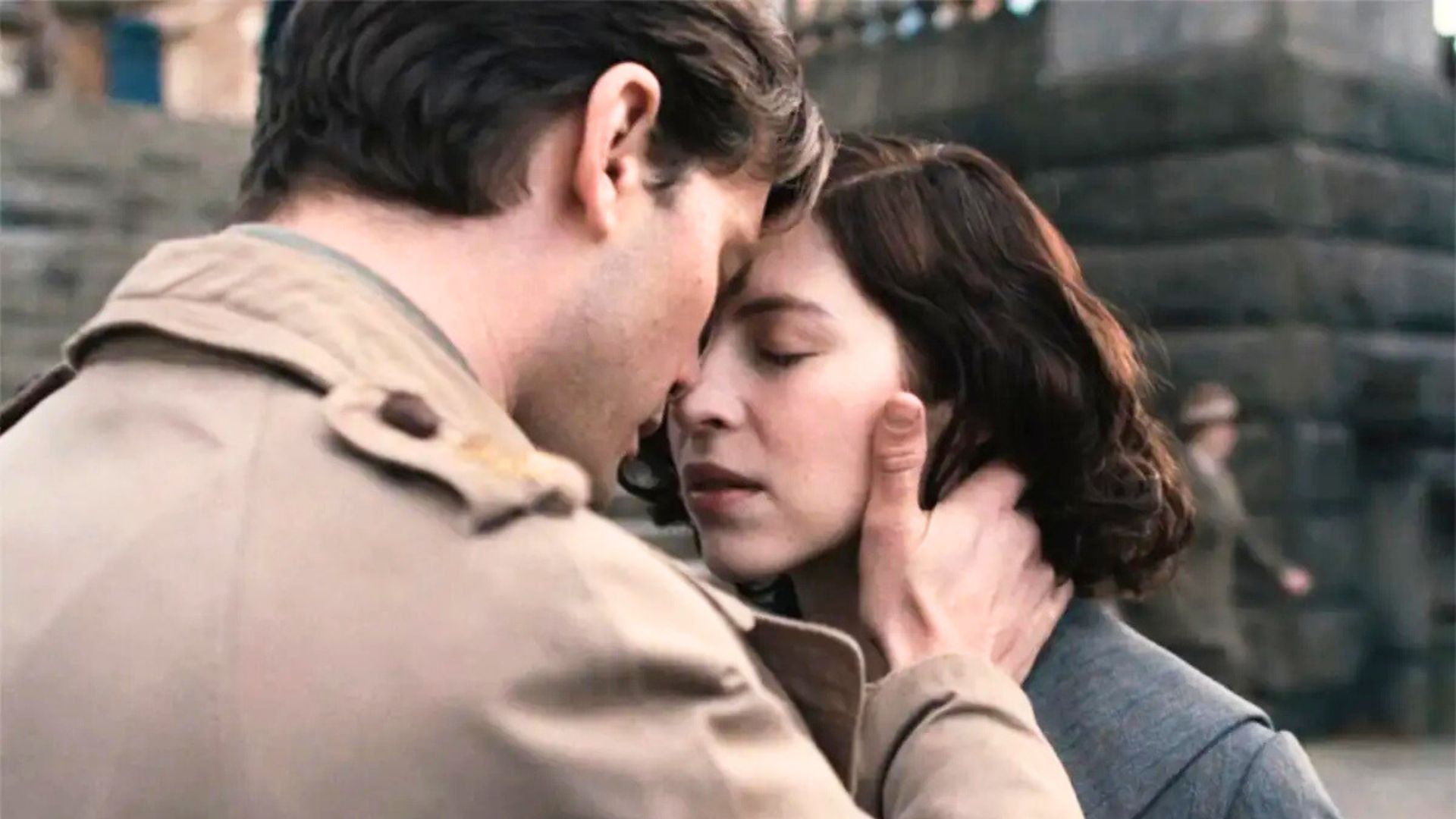 Henry holds Julia's face in his hands, foreheads pressed together.